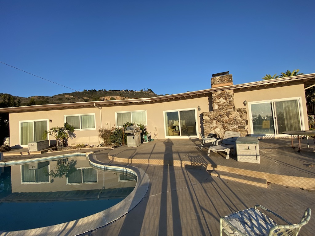 an image of a backyard of the house with a pool