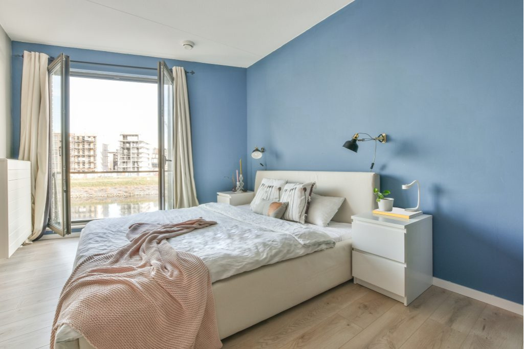 Bedroom with blue painted walls and a bed