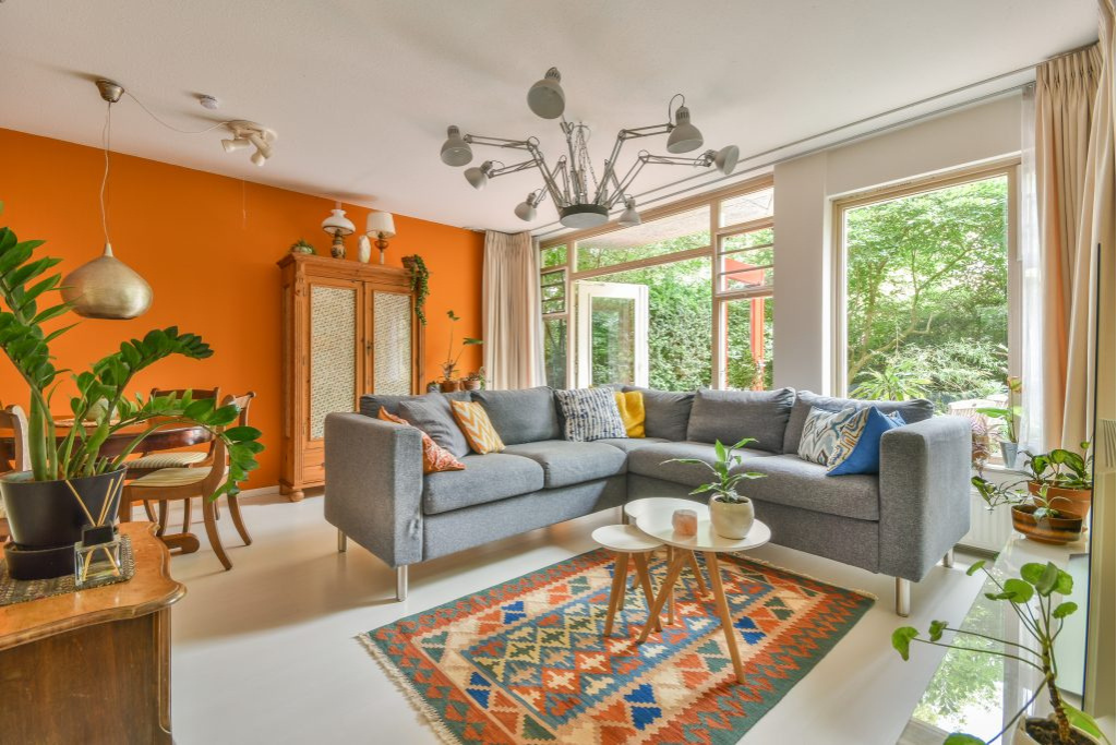 Dining room and living room with orange painted walls
