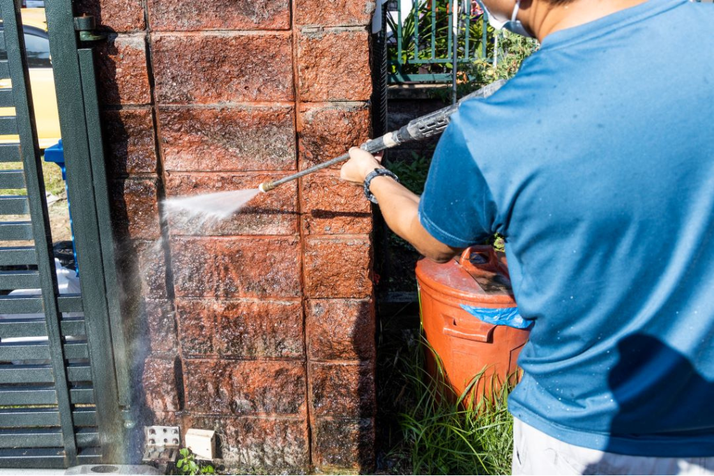 Home exterior being cleaned with pressure washing.