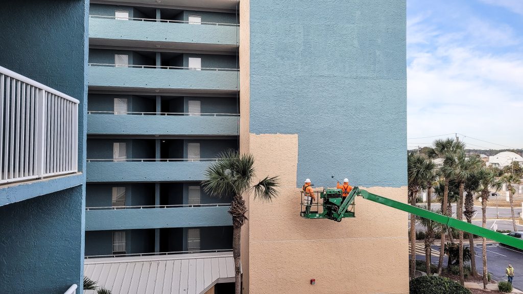 Commercial painting services being performed on a building exterior.