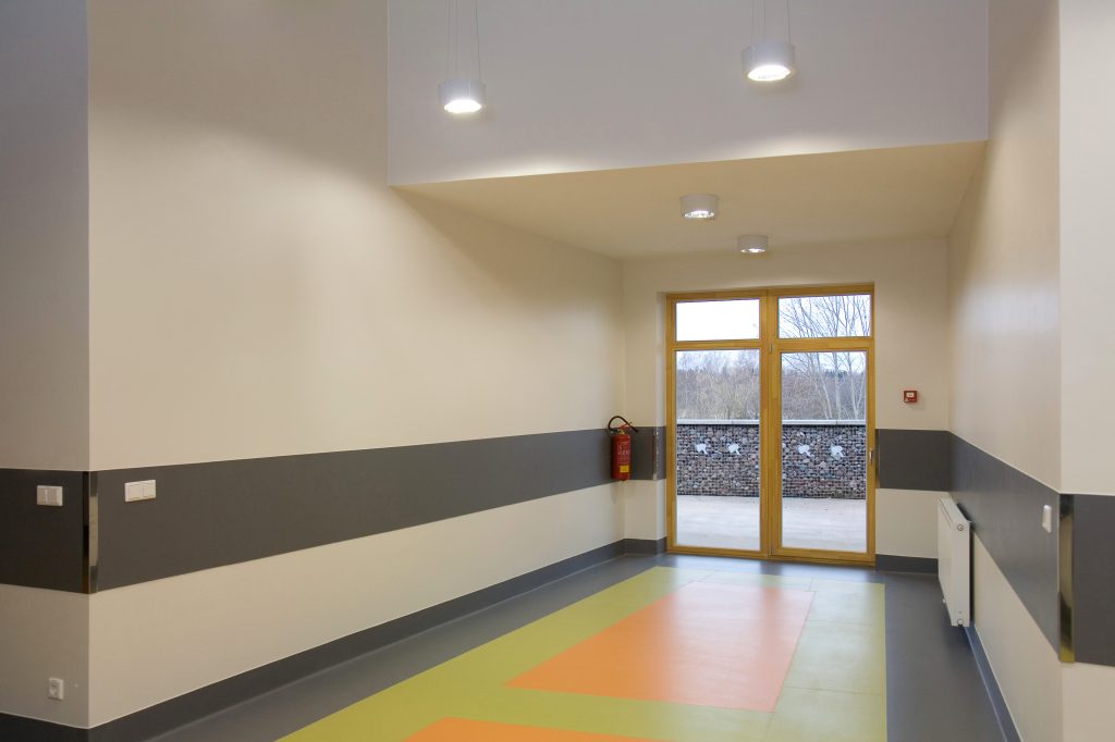 Commercial building entrance with freshly painted walls, highlighting the impact of professional commercial painting services.